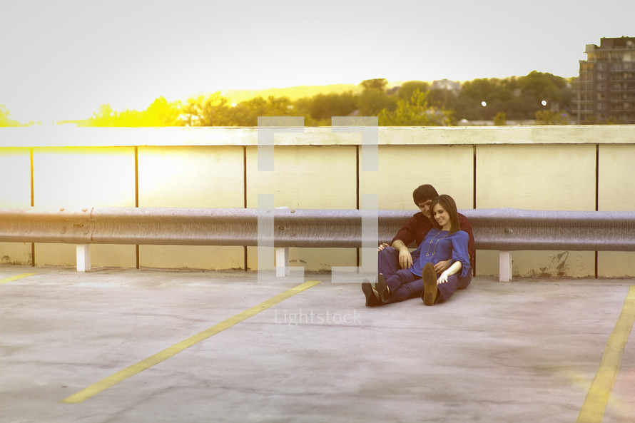 Happy couple outdoors on rooftop parking lot