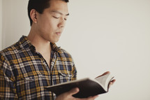 Asian man reading bible