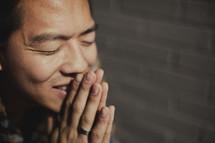 A man, eyes closed, in prayer