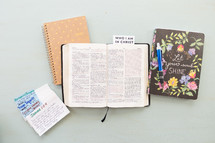 Who I am in Christ, notecards, prayer requests, open Bible, journal 
