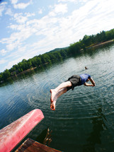 a man diving into a lake 