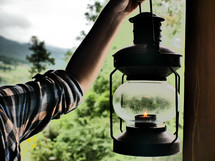 girl holding a lantern in daytime 