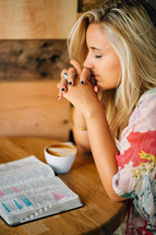 teen girl praying and an open Bible 