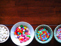 bowls of candy for decorated a gingerbread house at Christmas 