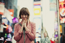 Woman praying in New York City
