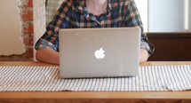 teen behind a laptop screen 