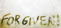 word forgiven written on fogged glass 
