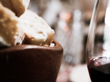 bread in a bowl and wine glass