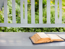 an old Bible on a front porch 