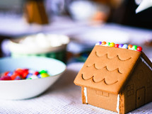 decorating a gingerbread house at Christmas 