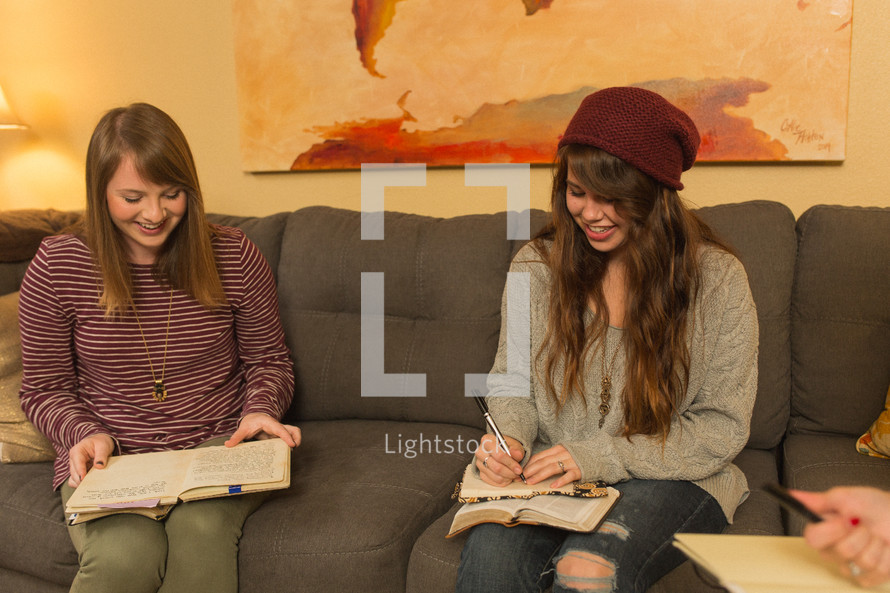 teen girls reading a Bible at a Bible study 
