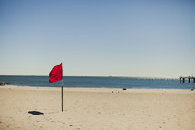 A red flag on the beach - no swimming