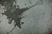 Tar splattered on concrete