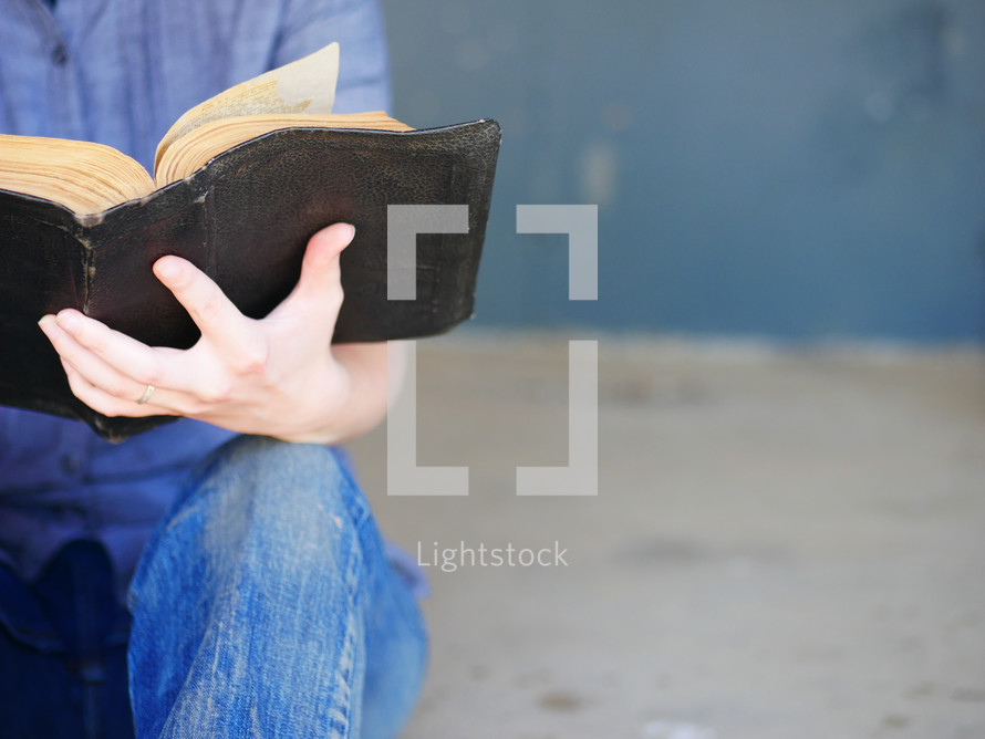 reading a worn Bible 
