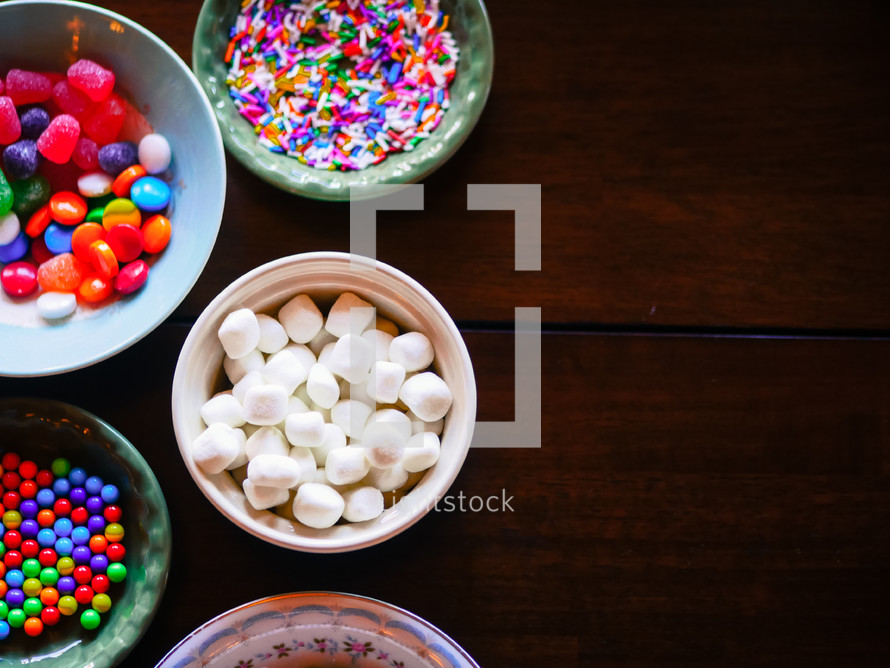 bowls of candy for decorating a gingerbread house at Christmas 