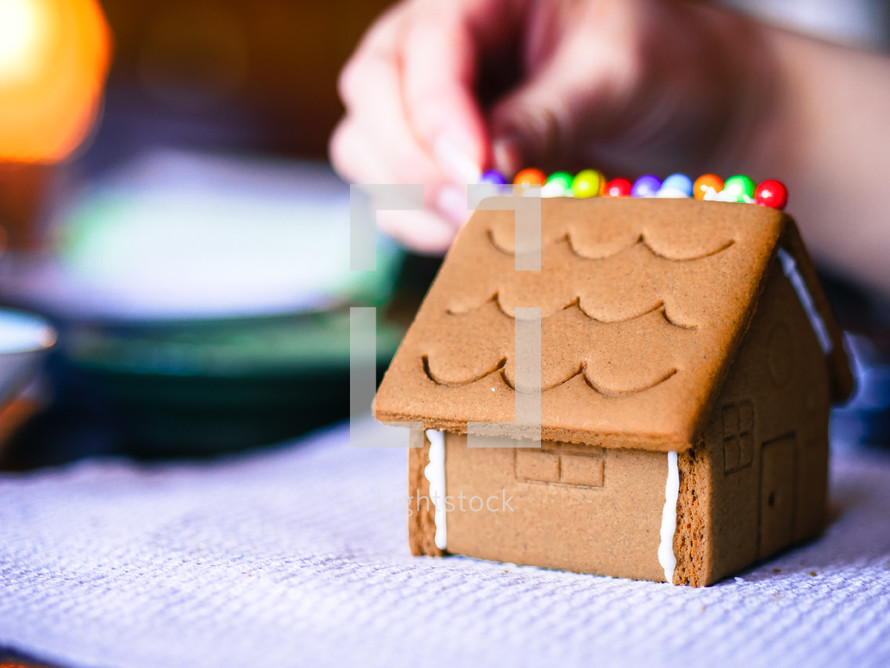 decorating a gingerbread house 