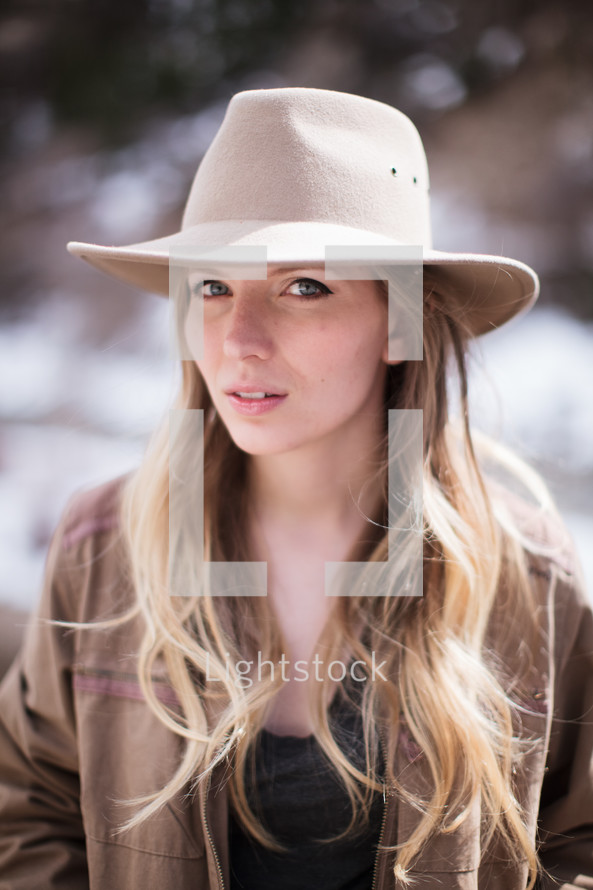 blonde with long hair in a hat 