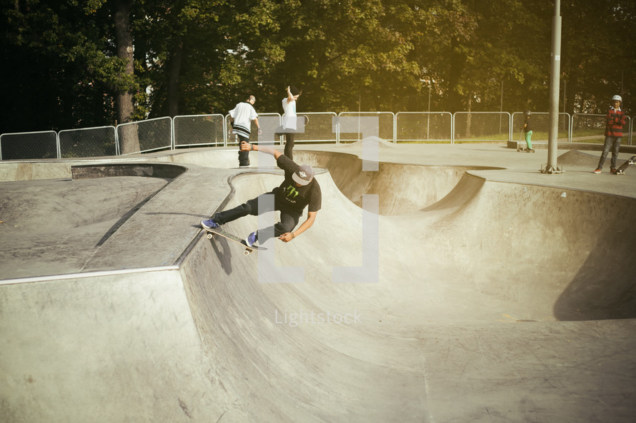 a man doing tricks on his skateboard in a skatepark  