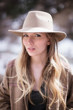 blonde with long hair in a hat 
