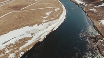 aerial view over an icy river 