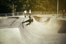 a man doing tricks on his skateboard in a skatepark  