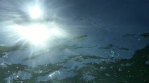 sunlight on water and bubbles under water 