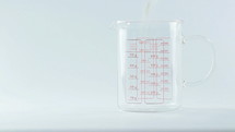 pouring powder in a measuring cup 