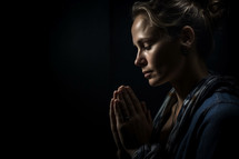 Photo of a woman praying with negative space