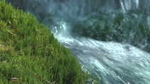 water flowing in a stream and moss