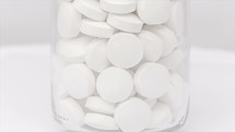 white pills in a bottle 