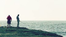 Men fishing in the ocean.