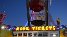 Ride tickets and Ferris Wheel at amusement park