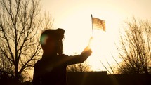 3 shots of a young child holding a waving American flag,  outdoors