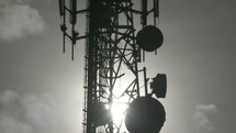 clouds moving and satellites on a communication tower