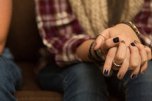woman's fingers laced in prayer