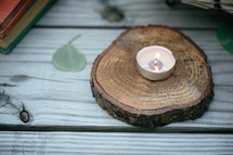 tea candle on a tree slice 