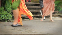 A double speed shot of feet of people walking past shows a range of international people - locals and tourists from around the world.  