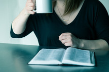 woman reading a Bible and drinking coffee 