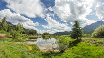 Timelapse of cloud movement over a lake in a valley between two mountain ranges.