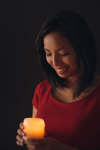 a woman holding a candle 