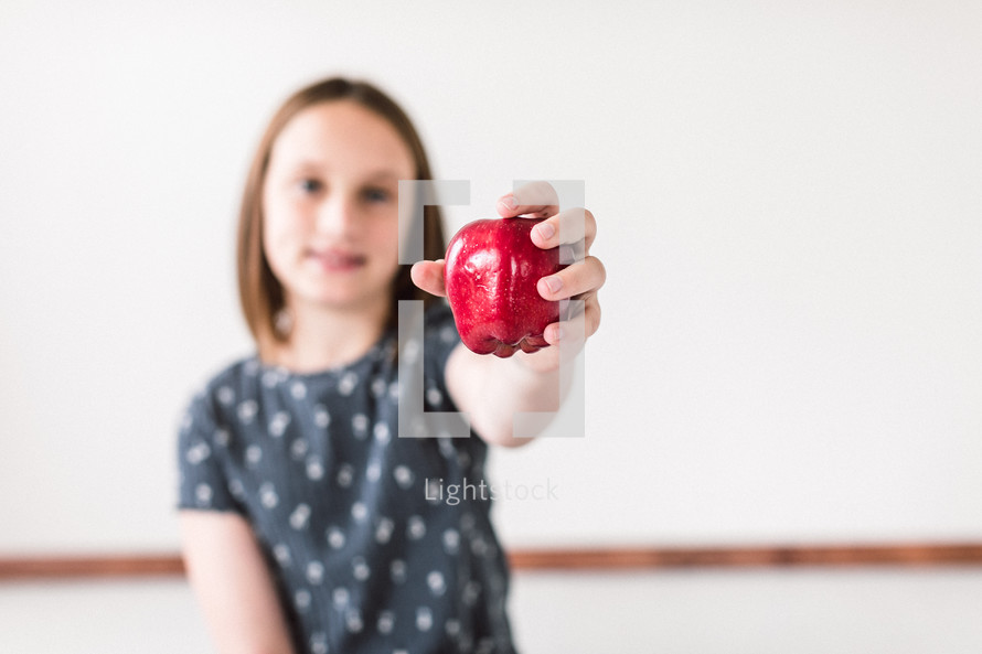girl holding an apple 