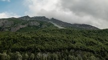 clouds moving over a mountaintop 