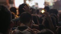 youth praying at a youth rally 