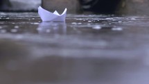Paper boat floating in water.
