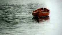 Empty rowboat in the water.