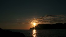 Timelapse of sunset over the water in Cinque Terre, Italy.
