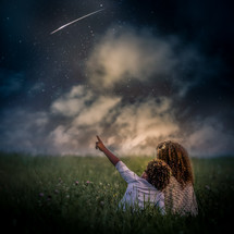 children pointing at shooting stars 