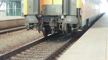 Train traveling on tracks near a platform.