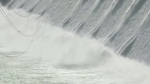 Water rushing across a dam.