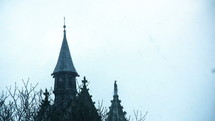 snow falling on church steeples 